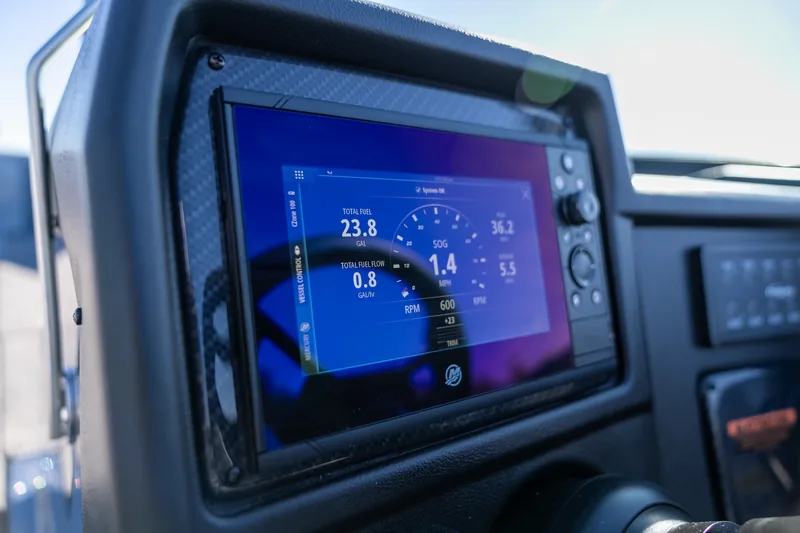 A large multifunction display mounted in the dash showing fuel, speed and RPM data.