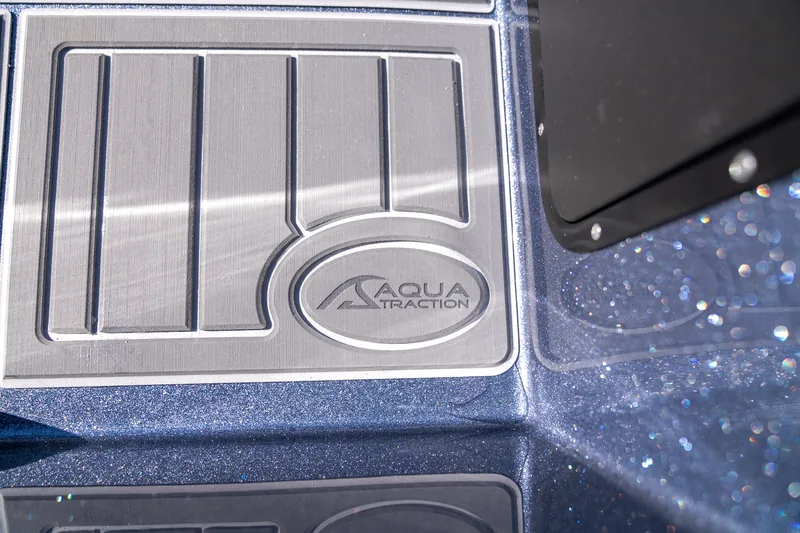 Close-up of a brushed metal Aqua Traction step pad set into the blue metalflake deck.