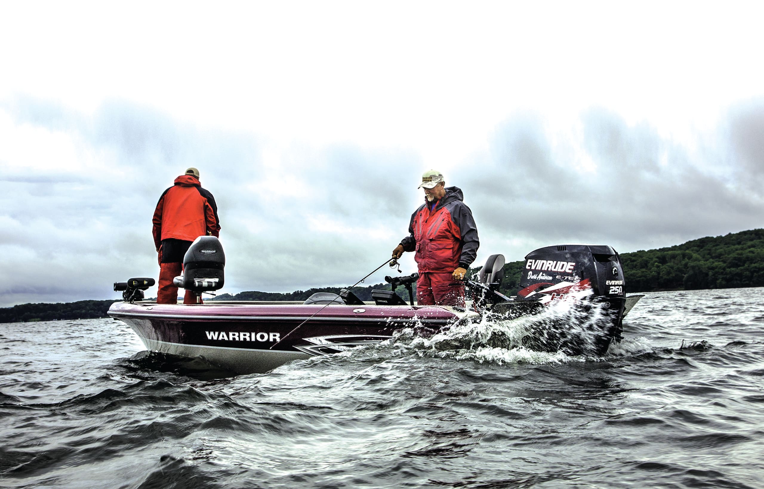 Two anglers in rain gear work rough water from Dave Andersen's Warrior boat, his signature Evinrude E-TEC 250 on the transom