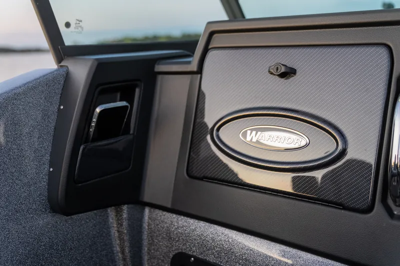 Warrior emblem detail on a console glove box door